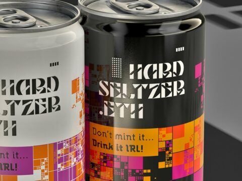 two cans of soda sitting next to each other